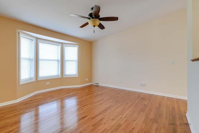 spare room featuring light hardwood / wood-style flooring and ceiling fan