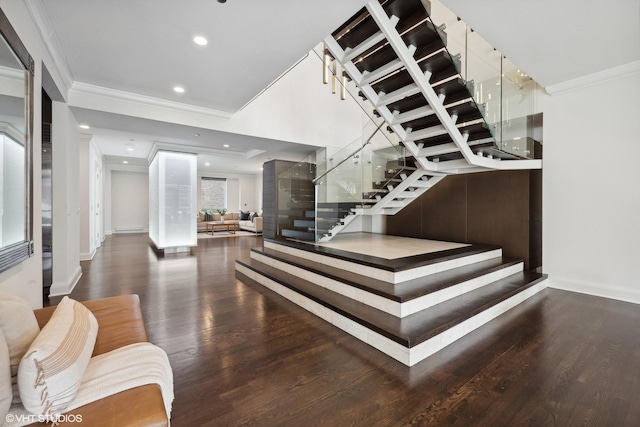 stairs with hardwood / wood-style floors and ornamental molding