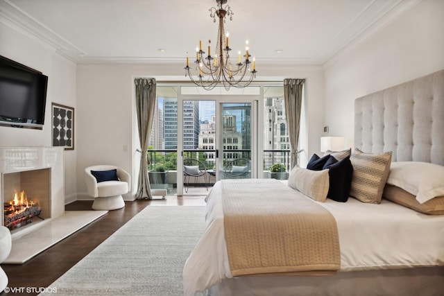 bedroom with crown molding, dark wood-type flooring, access to outside, and a high end fireplace