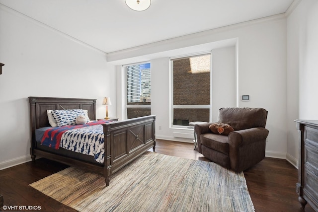 bedroom featuring ornamental molding and dark hardwood / wood-style floors