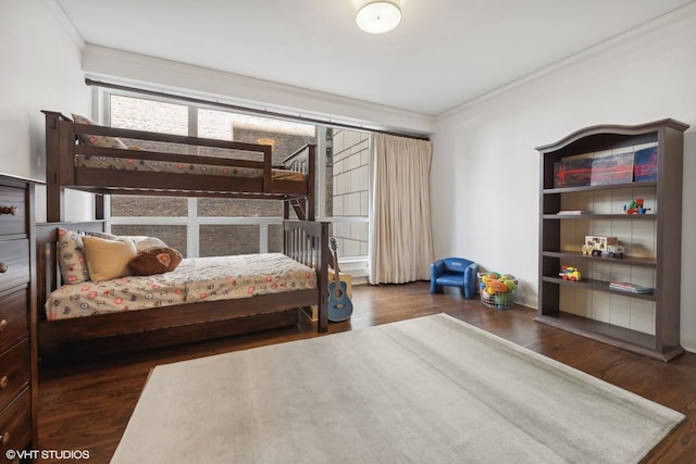 bedroom with crown molding and dark wood-type flooring