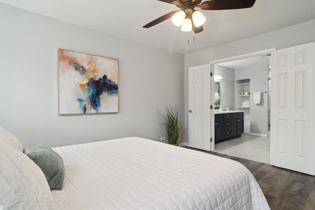 bedroom featuring sink, ensuite bath, light hardwood / wood-style flooring, and ceiling fan