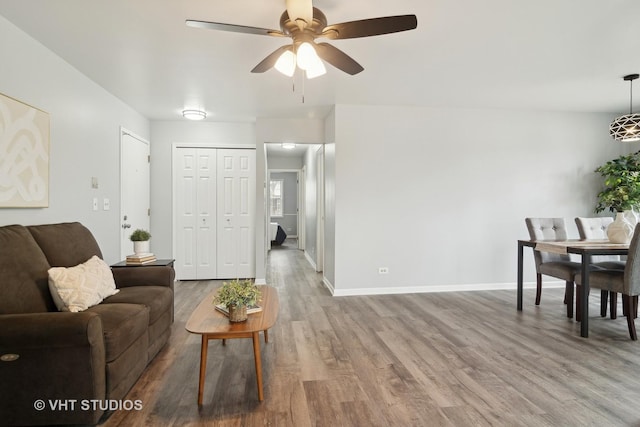 living room with hardwood / wood-style floors and ceiling fan