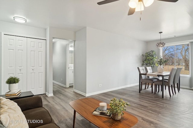 living room with wood-type flooring and ceiling fan