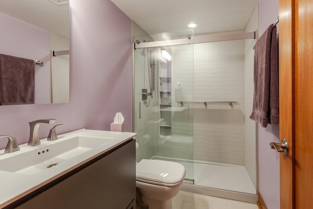 bathroom with an enclosed shower, vanity, tile patterned flooring, and toilet