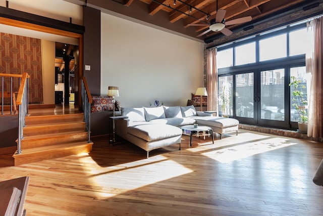 living room featuring hardwood / wood-style flooring, wood ceiling, beam ceiling, and french doors