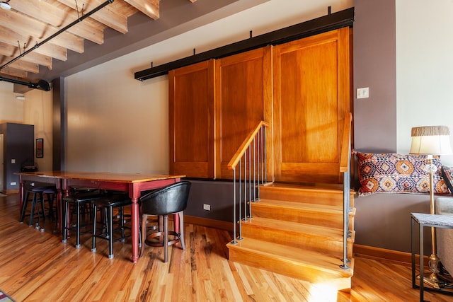 interior space with wood ceiling, beam ceiling, and light hardwood / wood-style flooring