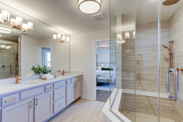 bathroom featuring vanity and a shower with door