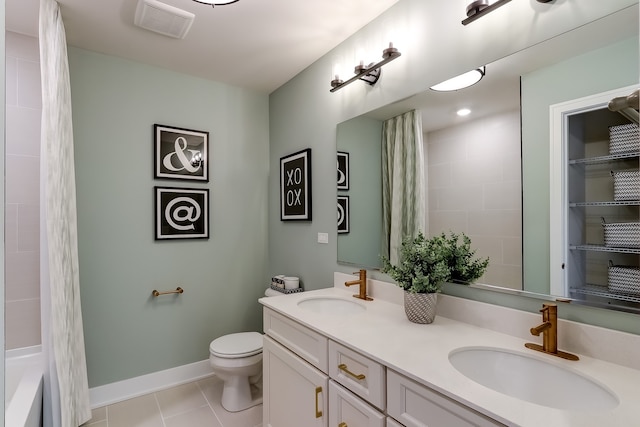 full bathroom with tiled shower / bath combo, vanity, tile patterned floors, and toilet