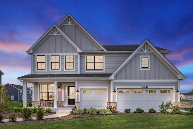 craftsman inspired home featuring a porch, a garage, and a yard