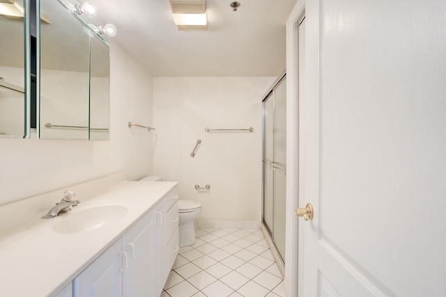 full bath with tile patterned flooring, toilet, vanity, baseboards, and a stall shower