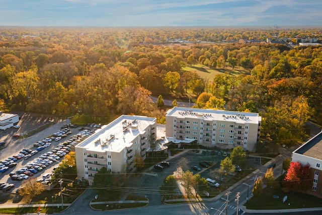 drone / aerial view featuring a wooded view