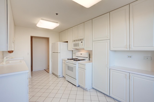 kitchen with light countertops, white appliances, a sink, and white cabinets