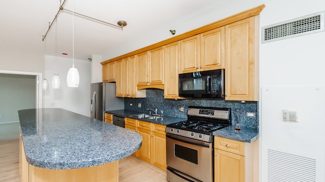 kitchen with light brown cabinetry, sink, a center island, decorative backsplash, and black appliances