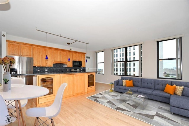 kitchen featuring stainless steel refrigerator with ice dispenser, wine cooler, rail lighting, tasteful backsplash, and light hardwood / wood-style floors