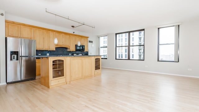 kitchen featuring light hardwood / wood-style flooring, light brown cabinetry, stainless steel fridge, and track lighting