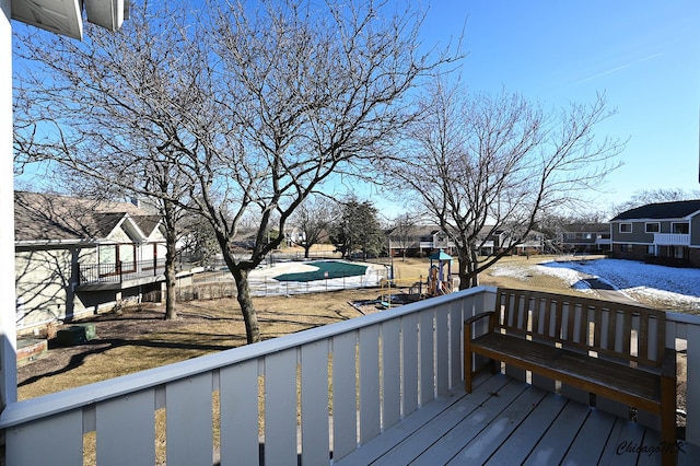 deck featuring a covered pool