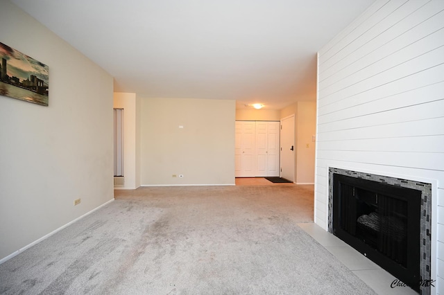 unfurnished living room featuring light carpet