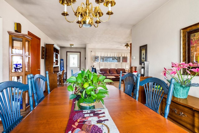 dining space featuring hardwood / wood-style floors and ceiling fan with notable chandelier