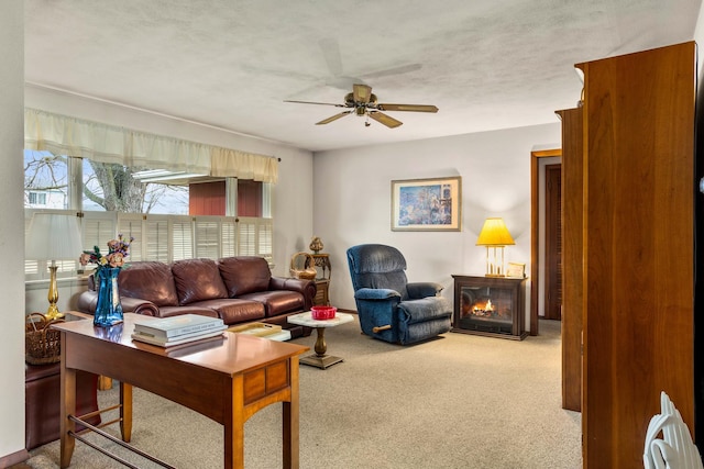 carpeted living room featuring a textured ceiling and ceiling fan