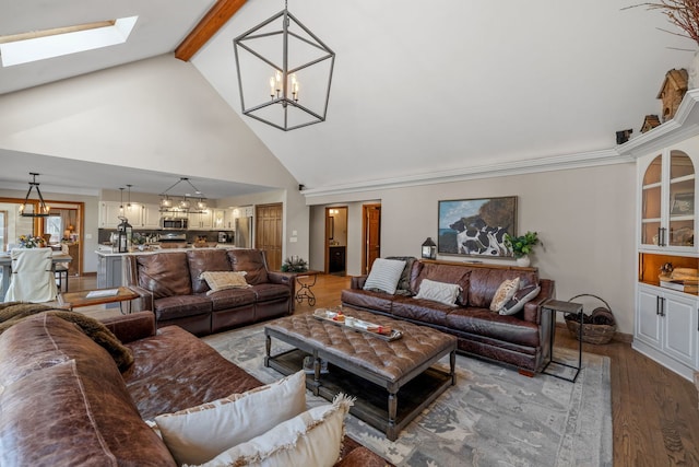 living room with high vaulted ceiling, a skylight, beam ceiling, a notable chandelier, and light wood-type flooring