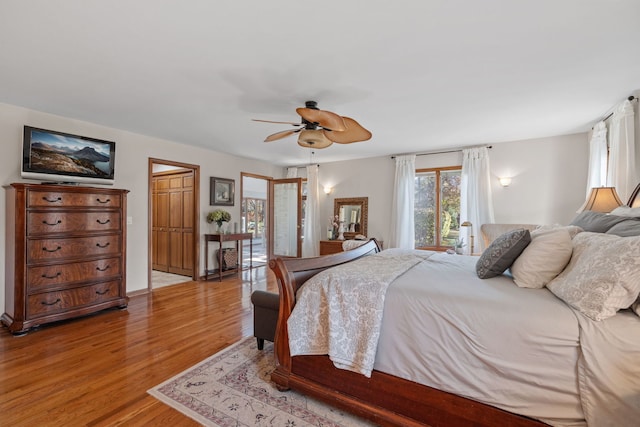 bedroom with light hardwood / wood-style flooring and ceiling fan