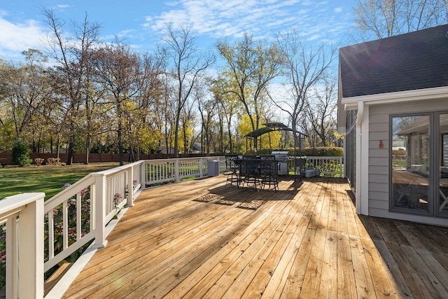 wooden terrace with grilling area and a lawn