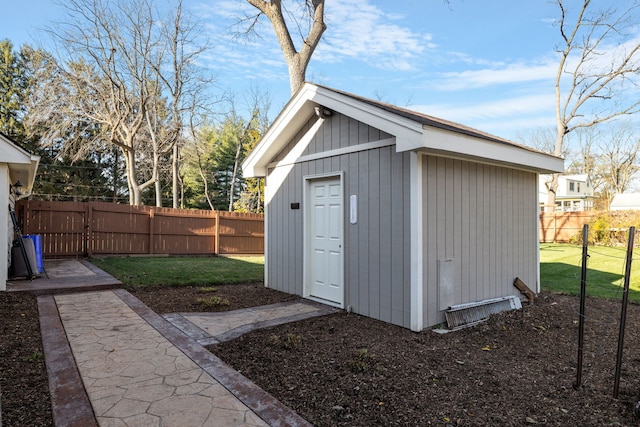 view of outbuilding featuring a lawn