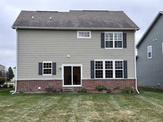 back of house with a lawn