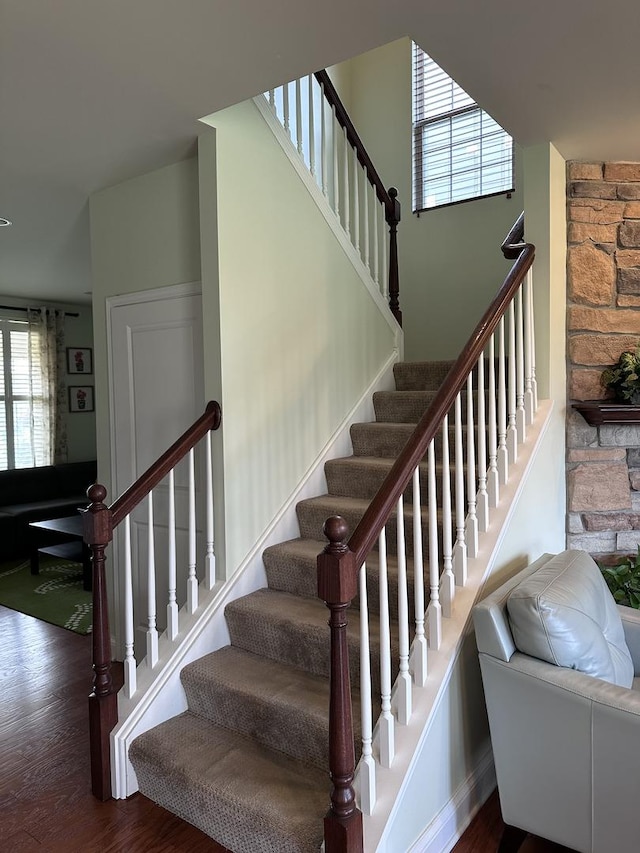 staircase with hardwood / wood-style flooring