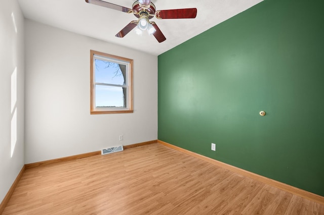 empty room with light wood-type flooring, baseboards, visible vents, and ceiling fan