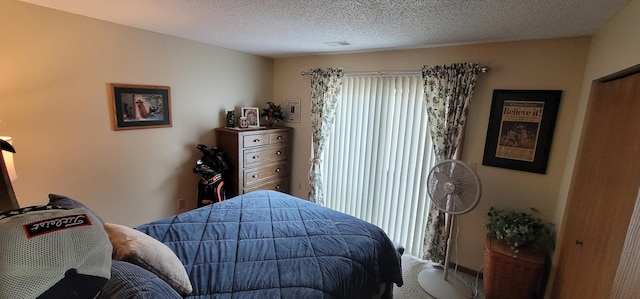 carpeted bedroom featuring multiple windows and a textured ceiling