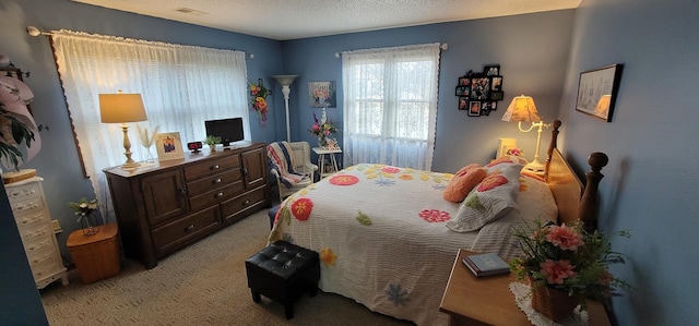 bedroom featuring light carpet and a textured ceiling