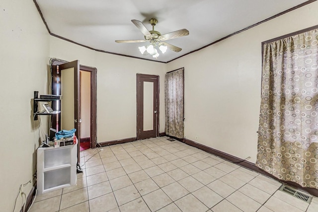 foyer entrance featuring crown molding, light tile patterned floors, and ceiling fan