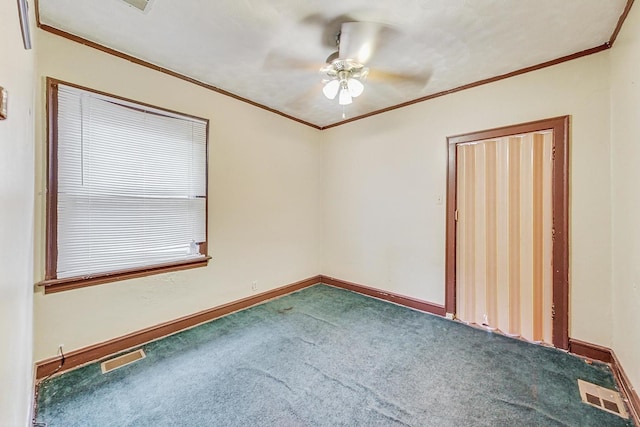 carpeted empty room with crown molding and ceiling fan