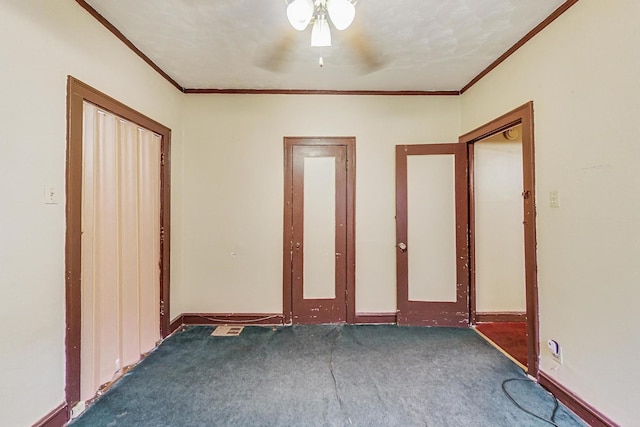 unfurnished room featuring dark carpet and ornamental molding