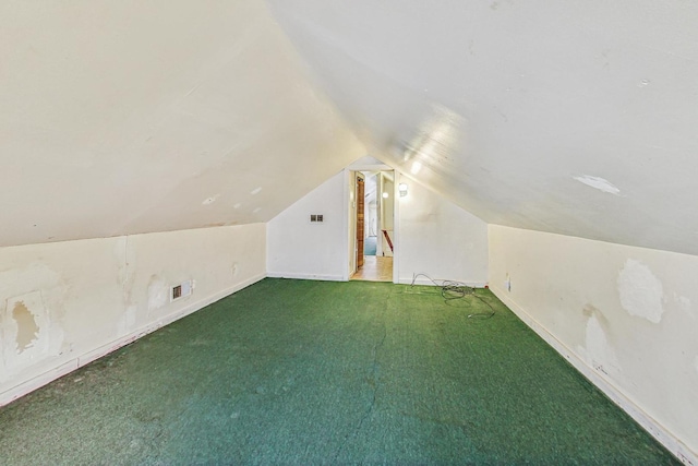 additional living space featuring carpet floors and vaulted ceiling