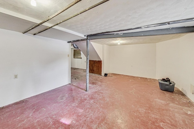 basement featuring a textured ceiling