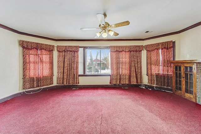 empty room with crown molding, ceiling fan, and carpet floors