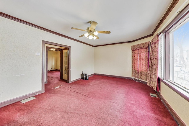 empty room with ceiling fan, ornamental molding, a healthy amount of sunlight, and carpet flooring