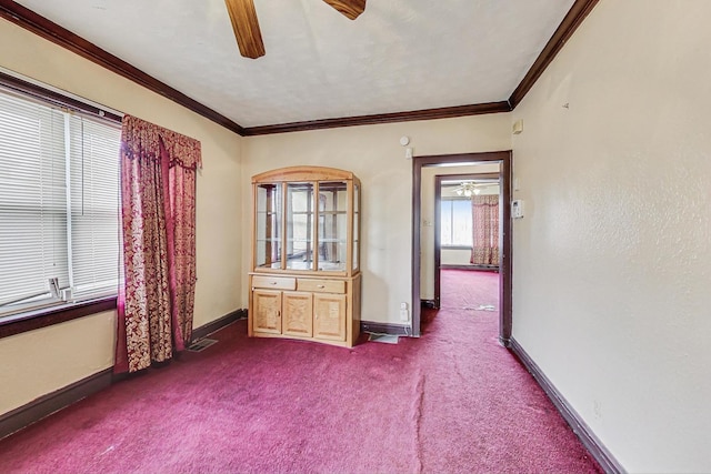 empty room featuring ornamental molding, carpet floors, and ceiling fan