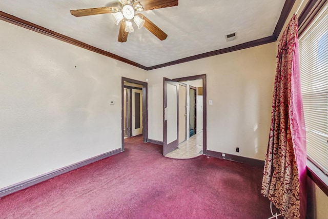 spare room featuring crown molding, light colored carpet, and ceiling fan