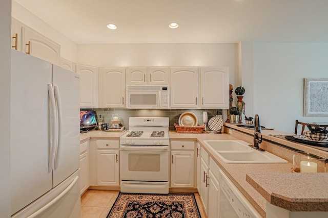 kitchen with sink, tasteful backsplash, light tile patterned floors, kitchen peninsula, and white appliances