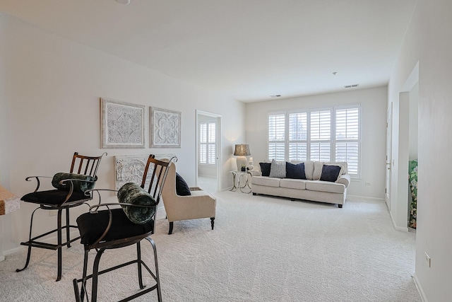 living room with light carpet and plenty of natural light