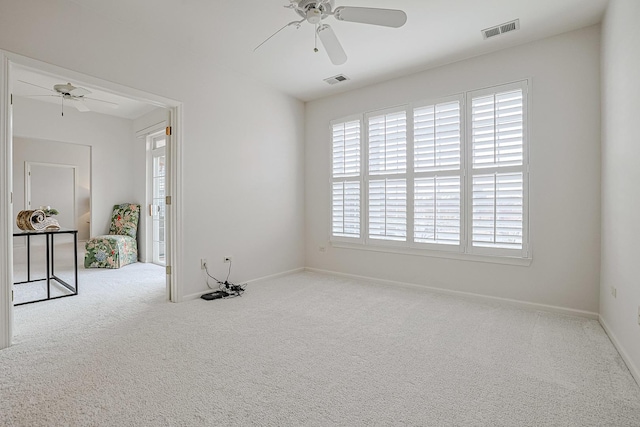 carpeted empty room featuring ceiling fan