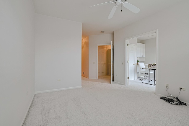 empty room with light colored carpet and ceiling fan