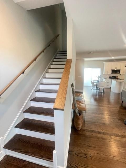 staircase with wood-type flooring