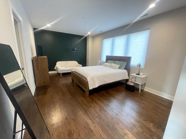 bedroom featuring dark hardwood / wood-style flooring