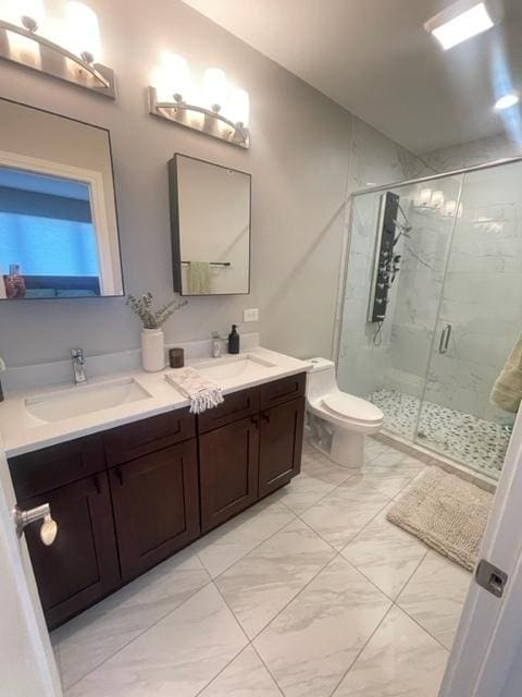 bathroom featuring vanity, an enclosed shower, and toilet