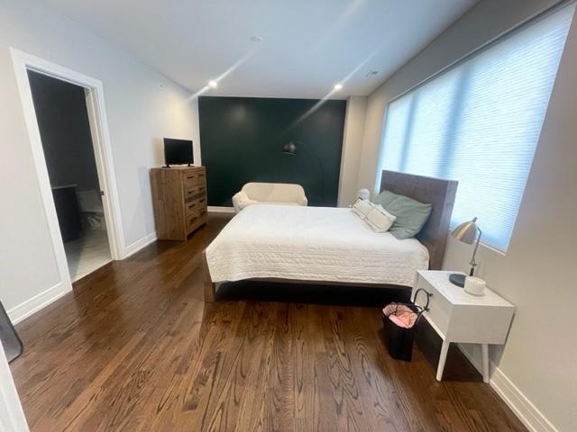 bedroom with dark wood-type flooring